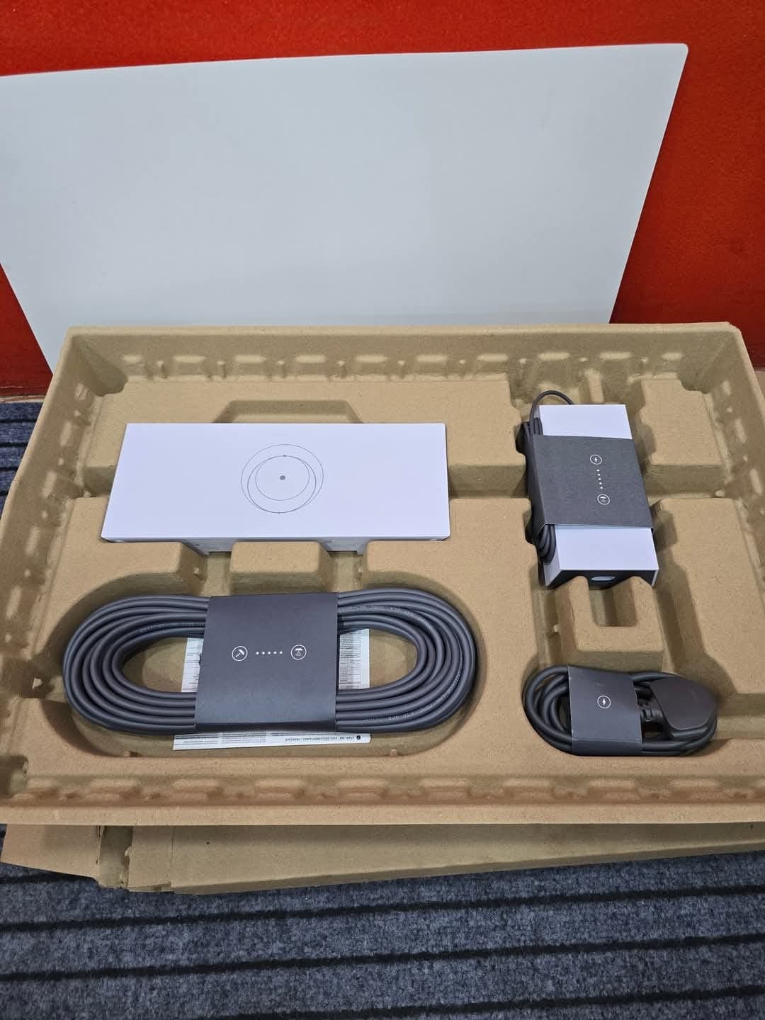 Starlink Standard Kit opened to show the dish, router, cable, and power supply